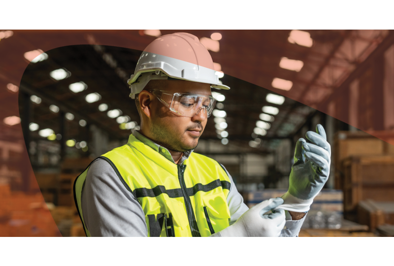 Man putting on PPE in industrial setting