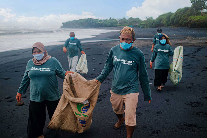 Product Community members picking up beach plastic
